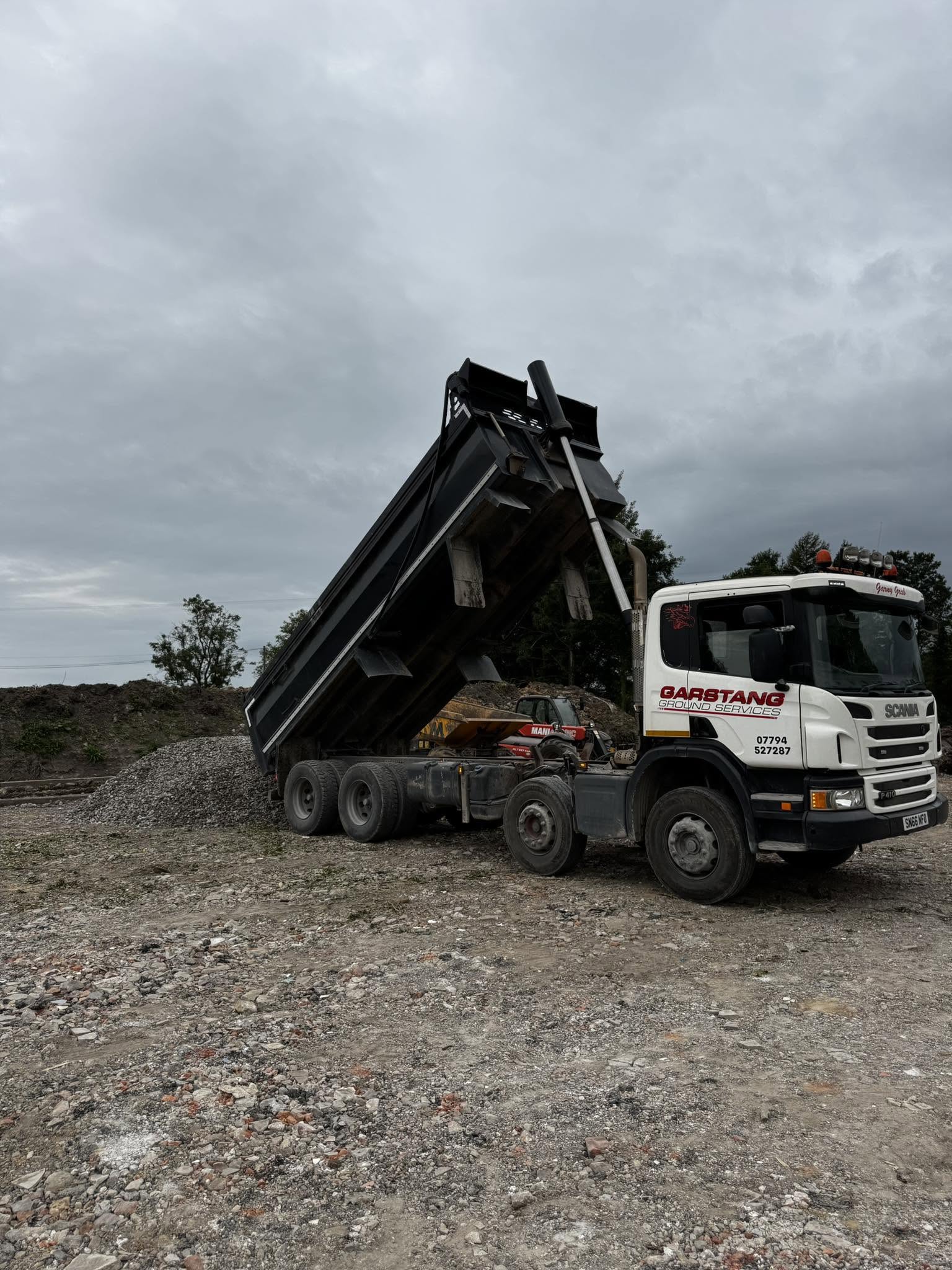 Construction site clearance with heavy machinery removing debris